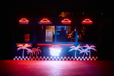 Pizza Hut, meanwhile, hosted a slice shop at Desert Nights, where guests could choose between cheese, pepperoni, veggie, and the brand’s signature “supreme” flavors. The activation also featured co-branded Pizza Hut x TAO Group Hospitality slice boxes and caricatures by the cartoon artist Napkin Killa.