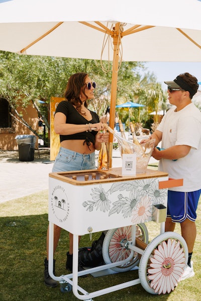 There was also a rose cart by Sainte Marguerite En Provence Rose (pictured), plus canned cocktails by Absolut RTD, comfy white Lovesac bean bags, a True Religion ice cream truck, and snacks from Cookie Pop OREO, Cereal Pop Fruity Pebbles, and Candy Pop Twix. Other partners included Franklin Pickleballs, Joola, Fanfix, ElectroLit, GoPuff, and Zen Water.